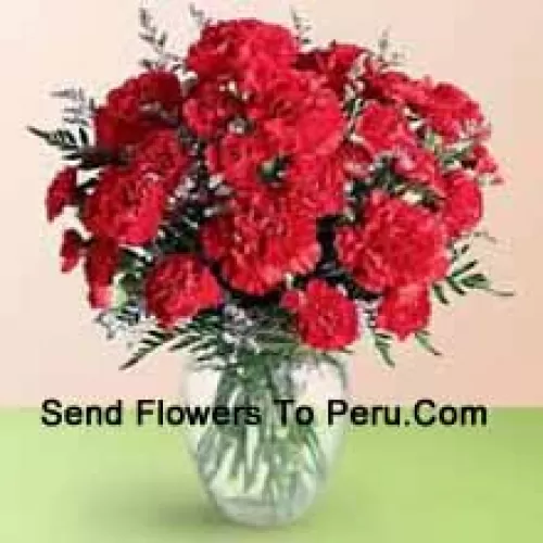 36 Red Carnations With Seasonal Fillers In A Glass Vase