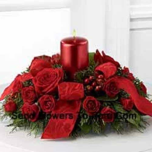 A crimson display of holiday warmth and cheer. Rich red roses and spray roses, red hypericum berries and lush holiday greens encircle a red metallic pillar candle to create a heart-warming centerpiece. Bedecked with bright red ribbon, this design will bring the spirit of the holiday season to their gatherings and celebrations with style and grace.? (Please Note That We Reserve The Right To Substitute Any Product With A Suitable Product Of Equal Value In Case Of Non-Availability Of A Certain Product)